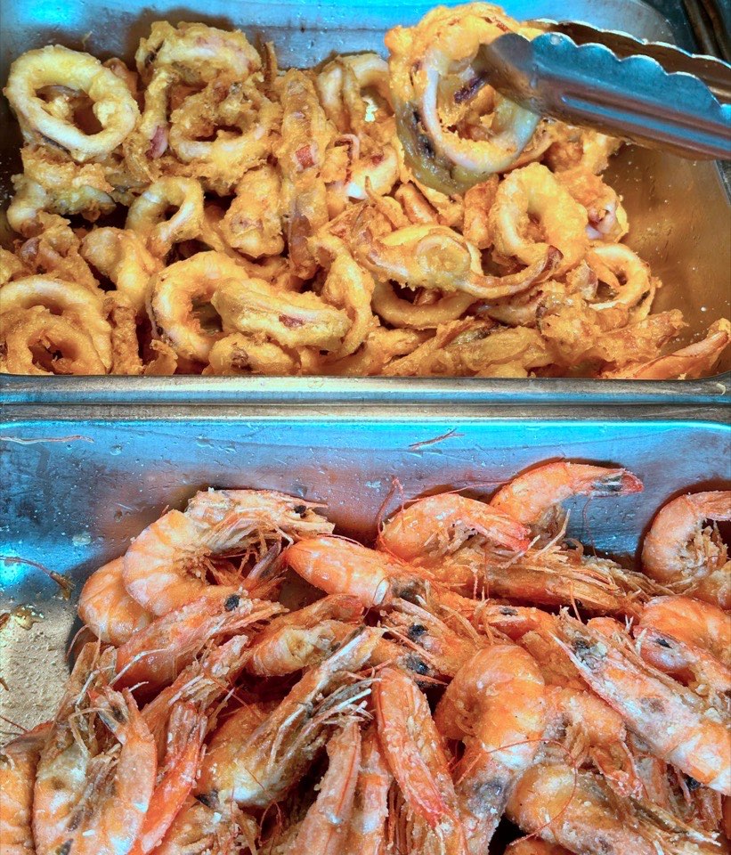 Fried squid rings and whole shrimp in buffet trays